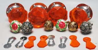 A collection of vintage 20th Century door furniture to include two orange glass faceted door