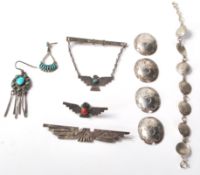 A selection of silver and silver white metal Native American Navajo jewellery to include a medallion