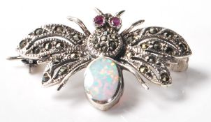 A stamped .925 silver and marcasite ladies brooch in the form of an insect with an opal set within
