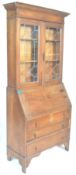 A 1920's Arts & Crafts oak bureau bookcase. The twin door bookcase having astragal glazed doors atop