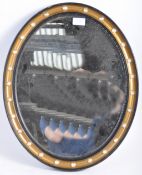 A VICTORIAN IRISH STYLE ANTIQUE EBONY AND GILT OVAL WALL MIRROR