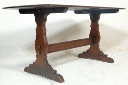 A 20th Century Ercol Old Colonial oak dark wood refectory dining table raised on Windsor supports