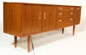 A vintage 20th century retro teakwood sideboard having a bank of three graduated drawers flanked
