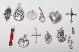A group of vintage ladies necklace pendants to include two St Christopher pendants, a pierced rose