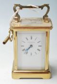 A mid 20th Century brass carriage clock retailed by Northern Goldsmiths Company having a carry