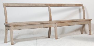 A 19th century Victorian elm wood station / railway / factory bench of rustic simple form. Raised on