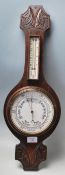 An early 20th century Made in England oak wall barometer. The heavy banjo barometer having