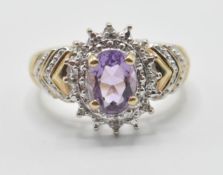 A ladies 9ct gold dress ring being set with an oval cut amethyst set with diamond accent stones with