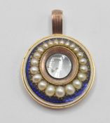 A 19th Century Victorian 9ct gold mourning pendant of round form being set with half seed pearls