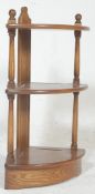 A contemporary Ercol Golden Dawn elm wood corner whatnot - etagere. The elm corner shelves having