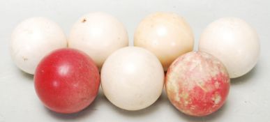 A early 20th century group of five antique ivory gaming balls. Colours include white and red balls.
