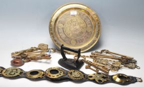A collection of 20th Century brassware to include a Persian islamic wall charger plate with raised