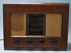 A vintage 20th Century walnut cased valve radio by Bush. Bush transfer logo to the top of the