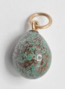 A 20th Century Russian egg pendant having a mottled blue and brown stone egg mounted on a gold