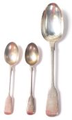 A group of three 19th Century Victorian silver spoons in the fiddle pattern to include a large spoon