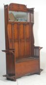 A Victorian 19th century oak hall stand settle. The hallstand with bench seat having a hinged lid