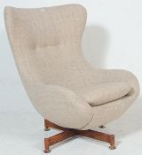 A retro mid century, circa 1970's swivel egg shaped easy chair - armchair. The chair having a 4