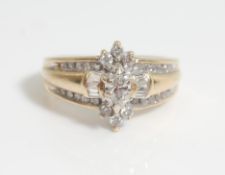 A 14 ct gold and diamond ladies ring having a central marquise cut diamond with further round and