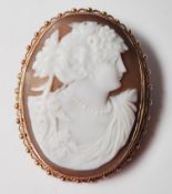 A hallmarked 9ct gold shell cameo brooch carved with a maiden. Stamped 9ct with a pin to verso.