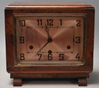 A vintage 1930's Art Deco mantle clock having a walnut case with a rectangular face and silvered