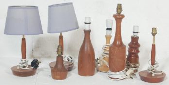 A COLLECTION OF SEVEN TEAK WOOD TABLE LAMPS