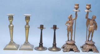 A collection of early 20th Century brass and spelter candlesticks to include a pair of figures stood
