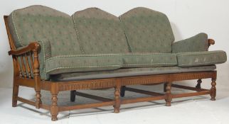 Ercol Furniture - A 20th century Old Colonial pattern 3 seat sofa settee in beech and elm wood.