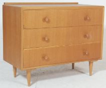 A vintage 20th century 1970’s teak wood Meredew chest of drawers having three full-size drawers with