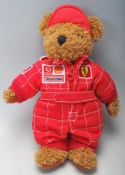 A vintage 20th century Michael Schumacher plush toy / bear with red Ferrari suit and Vodafone, Shell