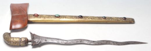 An early 20th Century Indonesian Kris knife / dagger having a brass and coloured stone scabbard with