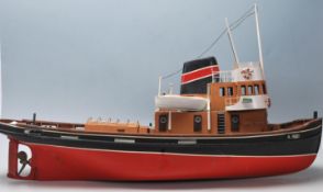A vintage 20th Century scratch built remote control boat having a red and black hull with model