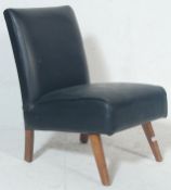 A vintage retro late 20th century bedroom chair having black leather upholstery raised on angular