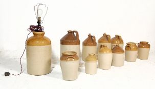 A collection of early 20th century antique stoneware advertising flagons. Of various shapes and