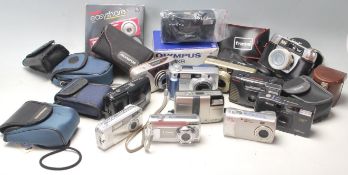 A collection of digital cameras and 35mm cameras to include Kodak easy share, Olympus C-310 zoom,