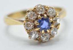 A hallmarked 18ct gold diamond and sapphire cluster ring being set with a central round cut