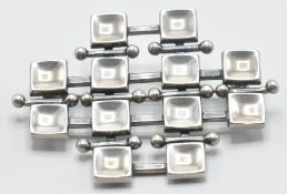 A Norwegian silver nordic modernist design brooch having a concentric squares design. Marked D. A