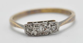 A stamped 18ct gold and platinum ring being illusion set in platinum with three with stones.