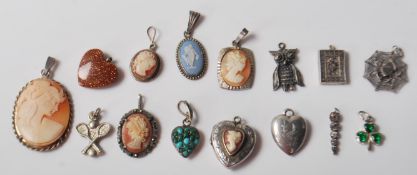 A group of fifteen vintage silver and pendants to include a heart shaped pendant set with a cameo