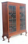 An antique style mahogany china display vitrine bookcase cabinet having a pediment top over art