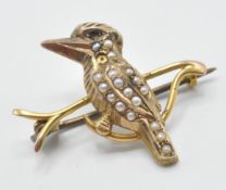 A late 19th Century 9ct gold brooch in the form of a kookaburra perched on a branch being set