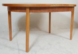 A retro vintage late 20th Century teak wood extendable dining table of oval form opening to reveal