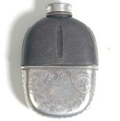 A vintage 20th Century silver white metal and glass whiskey hip flask bottle having a black
