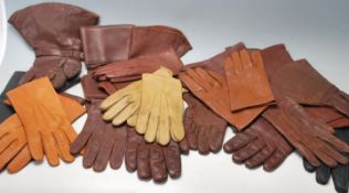 A good collection of early 20th century sorted brown leather gloves with metal buttons and leather