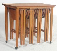 A retro vintage mid 20th century teak nest of tables in the manner of Carlo Jensen. The nest