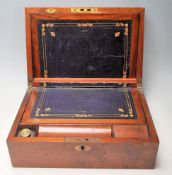 An antique Georgian / 19th Century walnut writing box having a curved hinged lid with a central