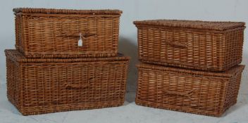 A collection of 4 vintage wicker baskets each having a hinged lid to the top with leather straps
