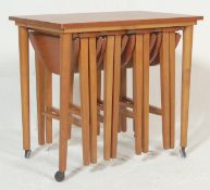 A vintage retro 20th century teak wood side table with four folding occasional / nest of four