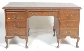 A 1940's large oak Queen Anne revival oak twin pedestal office desk. Each pedestal being raised on