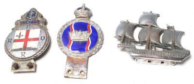 A pair of vintage automobilia classic car radiator grill badges to include an enamelled RNVR car