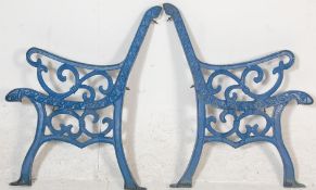 A pair of 20th Century antique  cast iron scroll work garden bench ends painted in blue.